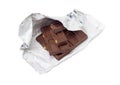 Pieces of the milk chocolate in open foil wrapper Royalty Free Stock Photo