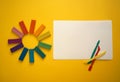 Pieces of multicolored plasticine for children against a yellow background.