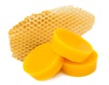 Pieces of natural beeswax and a piece of honey cell are isolated on a white background. Beekeeping products. Apitherapy.