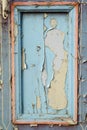 Pieces of old blue cracked paint on the vertical vintage door Royalty Free Stock Photo