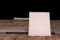 Old letter paper on a rustic wooden table, with blur background and space for copy. Royalty Free Stock Photo