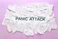 Pieces of paper and text PANIC ATTACK on color background