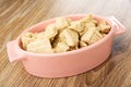 Pieces of peanut halva in oval bowl on wooden table