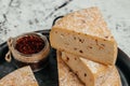 Pieces of pecorino cheese with dried tomatoes. Traditional italian hard cheese still life Royalty Free Stock Photo