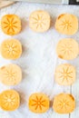 Pieces of persimmon fruit frame on white background.