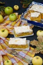 Pieces of pie with apples and meringues are located on a dark background