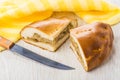 Pieces of pie with cabbage, yellow napkin and kitchen knife