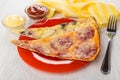 Pieces of pizza in plate, ketchup, mayonnaise inbowls, napkin, f