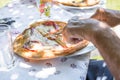 Pieces of pizza on a plate on a table with tablecloth and cutlery, Germany