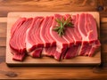 Pieces of pork meat with rosemary and thyme leaves on wood plate, raw fresh pork neck meat steaks concept
