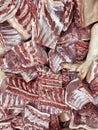 Pieces of pork meat for sale in local market. Food culture. Background, texture. Vertical photo