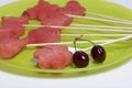 Pieces of the pulp of watermelon are cut with a stamp. They are given different forms. Stringed on skewers for a picnic. There are
