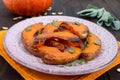 Pieces of pumpkin baked with herbs. Royalty Free Stock Photo