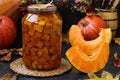 Pieces pumpkin canned for the winter in a jar located on a dark background