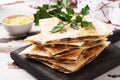 Pieces of quesadilla with mushrooms sour cream and cheese on a wooden stand with parsley leaves. Wooden background copy space