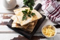 Pieces of quesadilla with mushrooms sour cream and cheese on a wooden stand with parsley leaves. Wooden background copy space