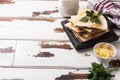 Pieces of quesadilla with mushrooms sour cream and cheese on a wooden stand with parsley leaves. Wooden background copy