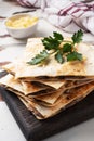 Pieces of quesadilla with mushrooms sour cream and cheese on a wooden stand with parsley leaves. Wooden background copy