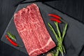 Pieces of raw marble beef black Angus for grilling on a stone Board Royalty Free Stock Photo