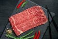 Pieces of raw marble beef black Angus for grilling on a stone Board Royalty Free Stock Photo