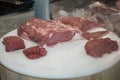 Pieces of Raw Meat on a White Round Table: Good Quality Beef Royalty Free Stock Photo