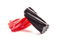Pieces of Red and Black Licorice on White Background
