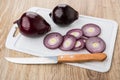 Pieces of red onion and kitchen knife on cutting board Royalty Free Stock Photo