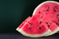 Pieces of refreshing watermelon on a dark wood background. Close-up photo. Fruit texture