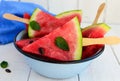 Pieces of ripe watermelon on a stick on a white background