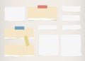 Pieces of ripped brown, white and lined blank note paper, colorful sticky, adhesive tapes are stuck on gray wall Royalty Free Stock Photo