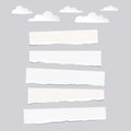 Pieces of ripped white blank and lined note, notebook paper strips with clouds on gray background