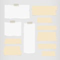 Pieces of ripped white blank note paper, brown sticky, adhesive tapes are stuck on gray wall Royalty Free Stock Photo