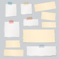 Pieces of ripped white, blank note paper, brown sticky, adhesive tapes are stuck on gray wall Royalty Free Stock Photo