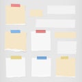 Pieces of ripped white, brown blank note paper, colorful sticky, adhesive tapes are stuck on gray wall Royalty Free Stock Photo