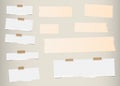 Pieces of ripped white, lined blank note paper, brown sticky, adhesive tapes are stuck on diagonal pattern wall Royalty Free Stock Photo