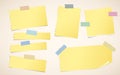 Pieces of ripped yellow blank notebook paper are stuck with striped sticky tape Royalty Free Stock Photo