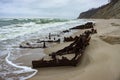 Pieces of rusty iron on the seashore, the remains of a ship on the sand