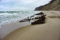 The remains of a ship on the sand, pieces of rusty iron on the seashore