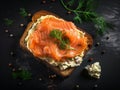 Pieces of salmon on a rectangular piece of bread spread with butter