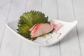 Pieces of sea bream sashimi on shiso leaf