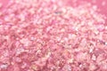 Pieces of shiny rose material on fabric