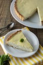 Pieces, slices of delicious homemade lemon cheesecake on plate with mint. Dessert Royalty Free Stock Photo