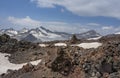 Pieces of solidified lava of the Elbrus volcano against the background of mountains and glaciers of the Main Caucasian