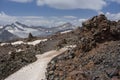 Pieces of solidified lava of the Elbrus volcano against the background of mountains and glaciers of the Main Caucasian