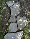 pieces of stones are laid out on the green grass Royalty Free Stock Photo