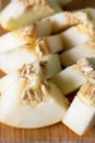 Pieces of Sweet Melon Lying on a Wooden Board Napkin Green Background Vertical Above