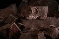 Pieces of tasty dark chocolate on background, closeup Royalty Free Stock Photo