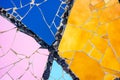 pieces of tiles of different patterns and bright colors forming abstract figures.