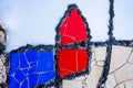 pieces of tiles of different patterns and bright colors forming abstract figures.