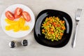 Pieces of tomato and sweet pepper, vegetable mix in plates Royalty Free Stock Photo